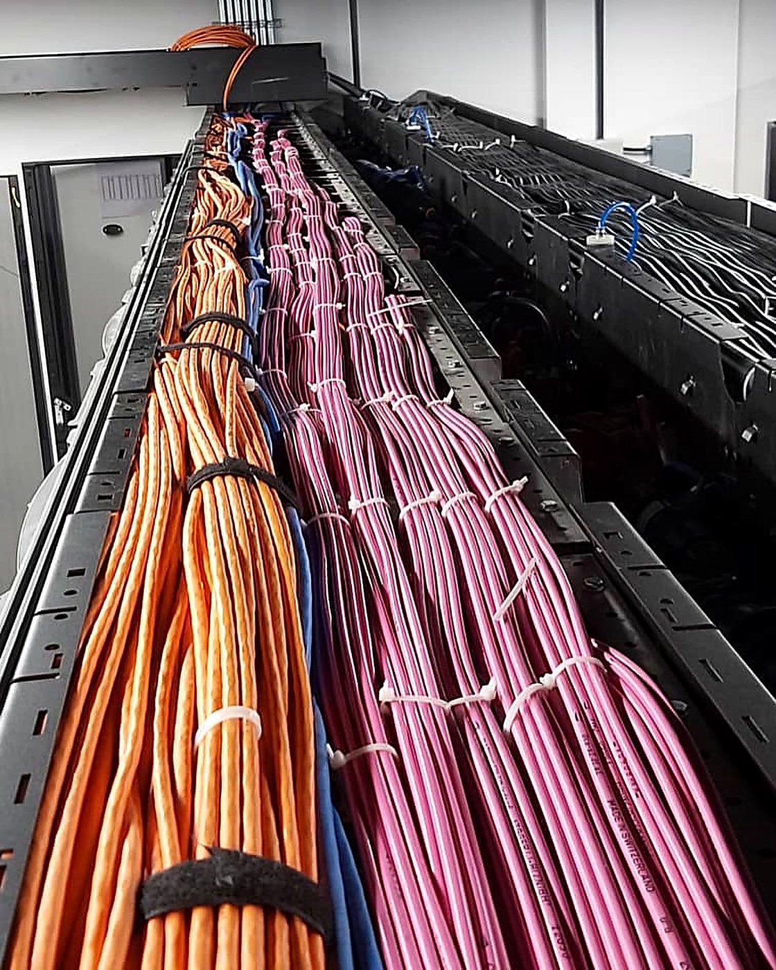 Cable tray populated with bundled and dressed power and data cables